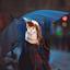 Lady standing in the rain with an umbrella over her head..jpg